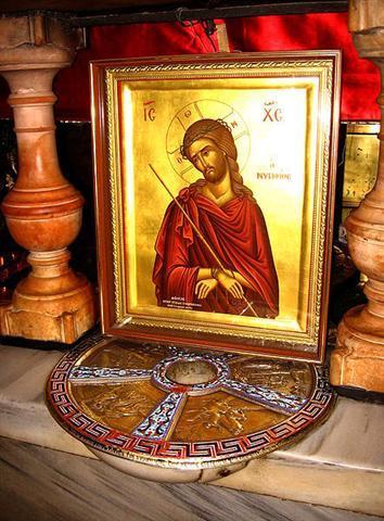 Red and yellow icon of Christ set amidst a marble structure