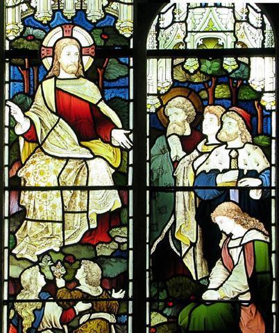 Richly coloured stained glass of Jesus speaking to several people