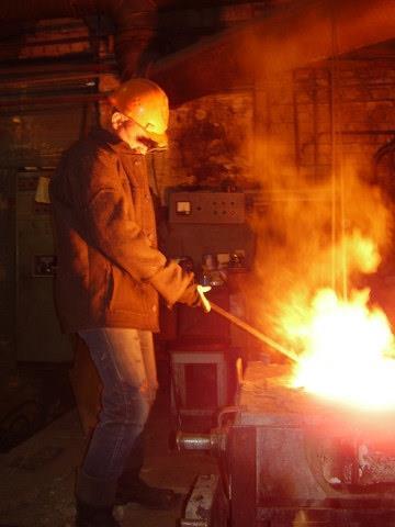Man standing over a fiery furnace